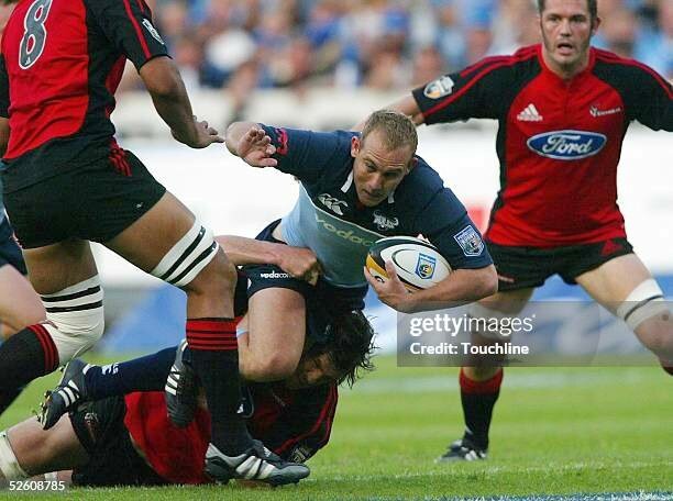 PRETORIA, SOUTH AFRICA - APRIL 9: (TOUCHLINE IMAGES ARE AVAILABLE TO CLIENTS IN THE UK, USA AND AUSTRALIA ONLY)  Ettienne Botha of the Bulls is tackled by Norm Maxwell of the Crusaders during the Super 12's match between the Bulls and the Crusaders played at Securicor Loftus Stadium April 9, 2005 in Pretoria, South Africa. (Photo by Touchline/Getty Images)
